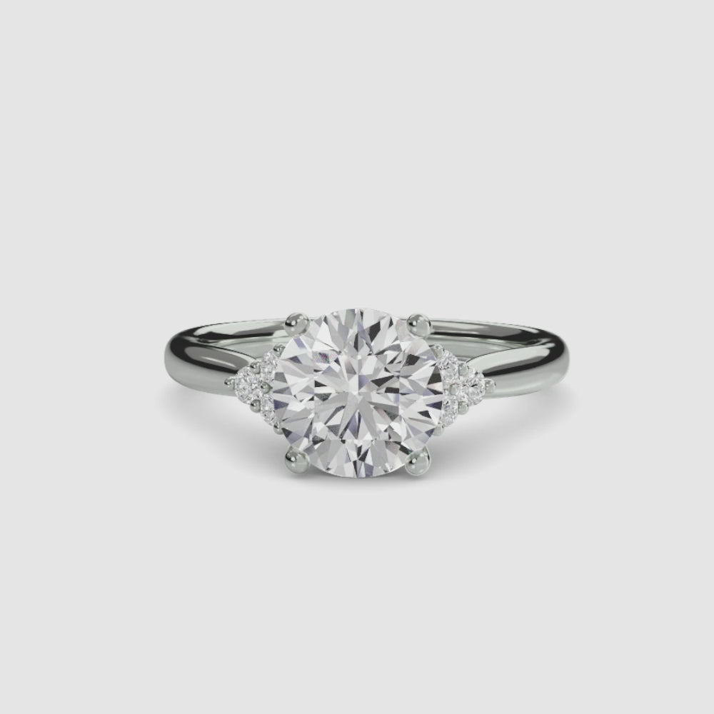 engagement-rings__solitaire-with-cluster-shoulders__shape-round__gold-white__00_video.mp4