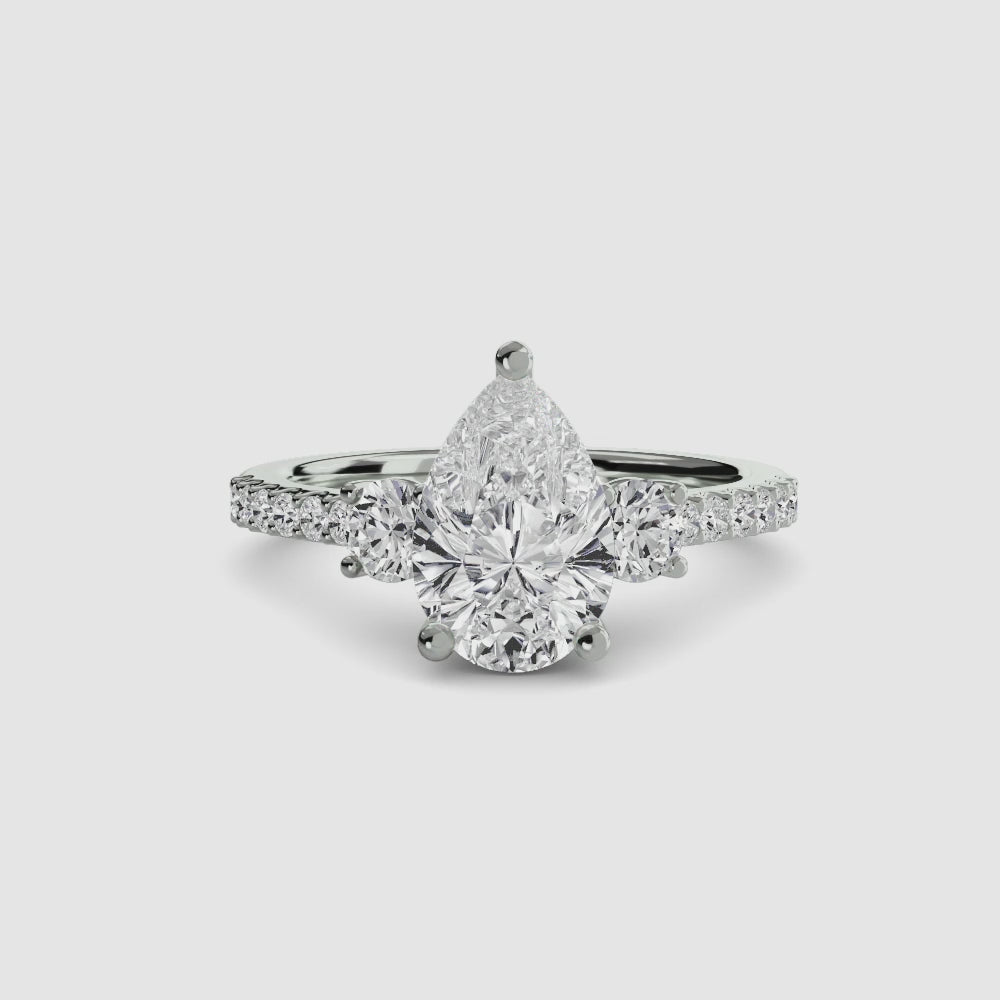 engagement-rings__three-stone-ring-with-pave-band-5__shape-pear__gold-white__00_video.mp4